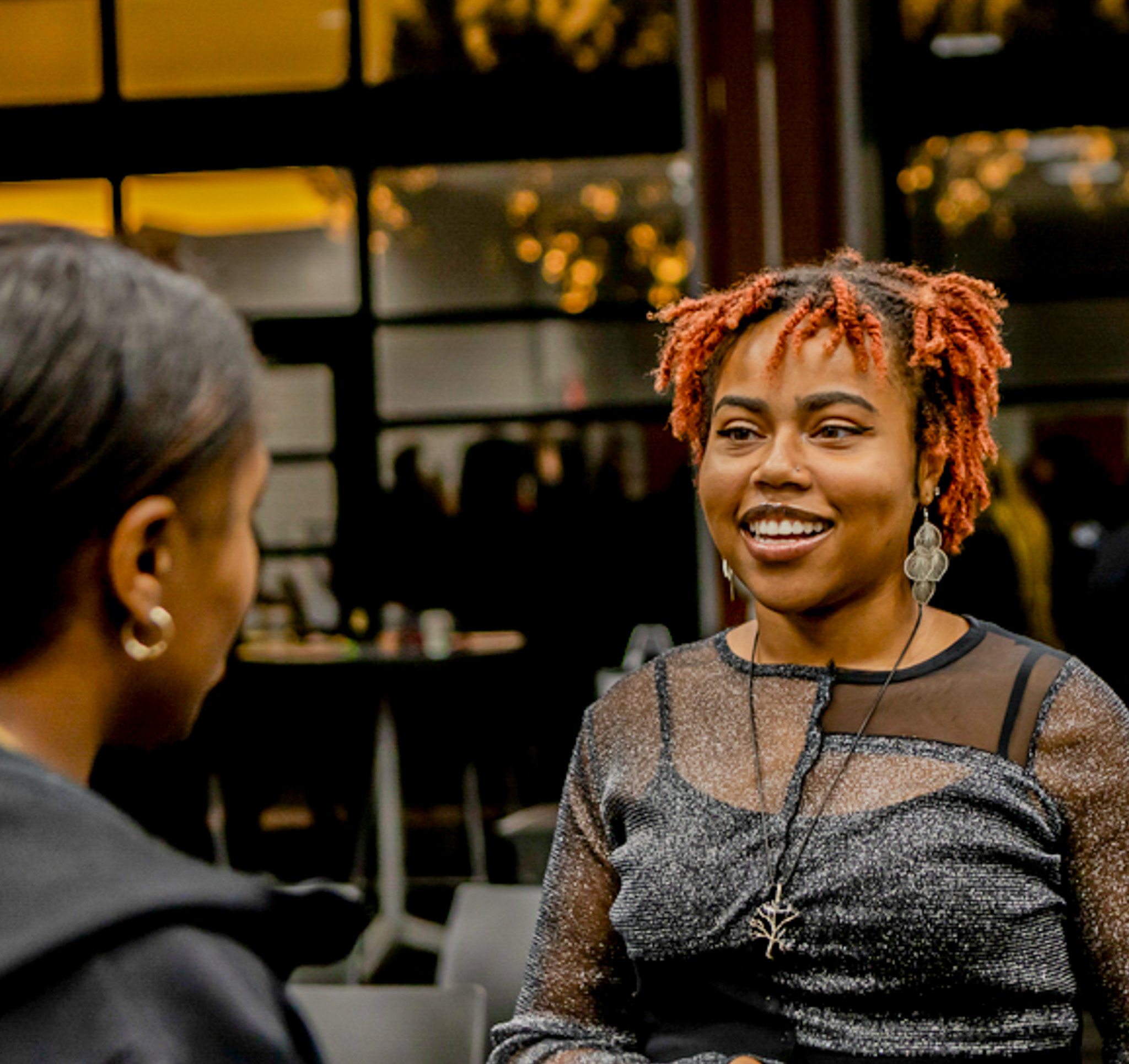 A photo of a lady talking to another person at a conference