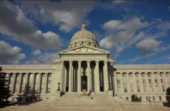 photo of the Missouri state capitol building against a blue sky with white clouds
